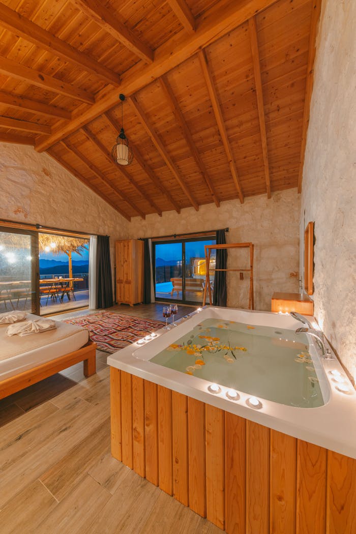 Elegant bedroom with hot tub overlooking a stunning resort view in Turkey.